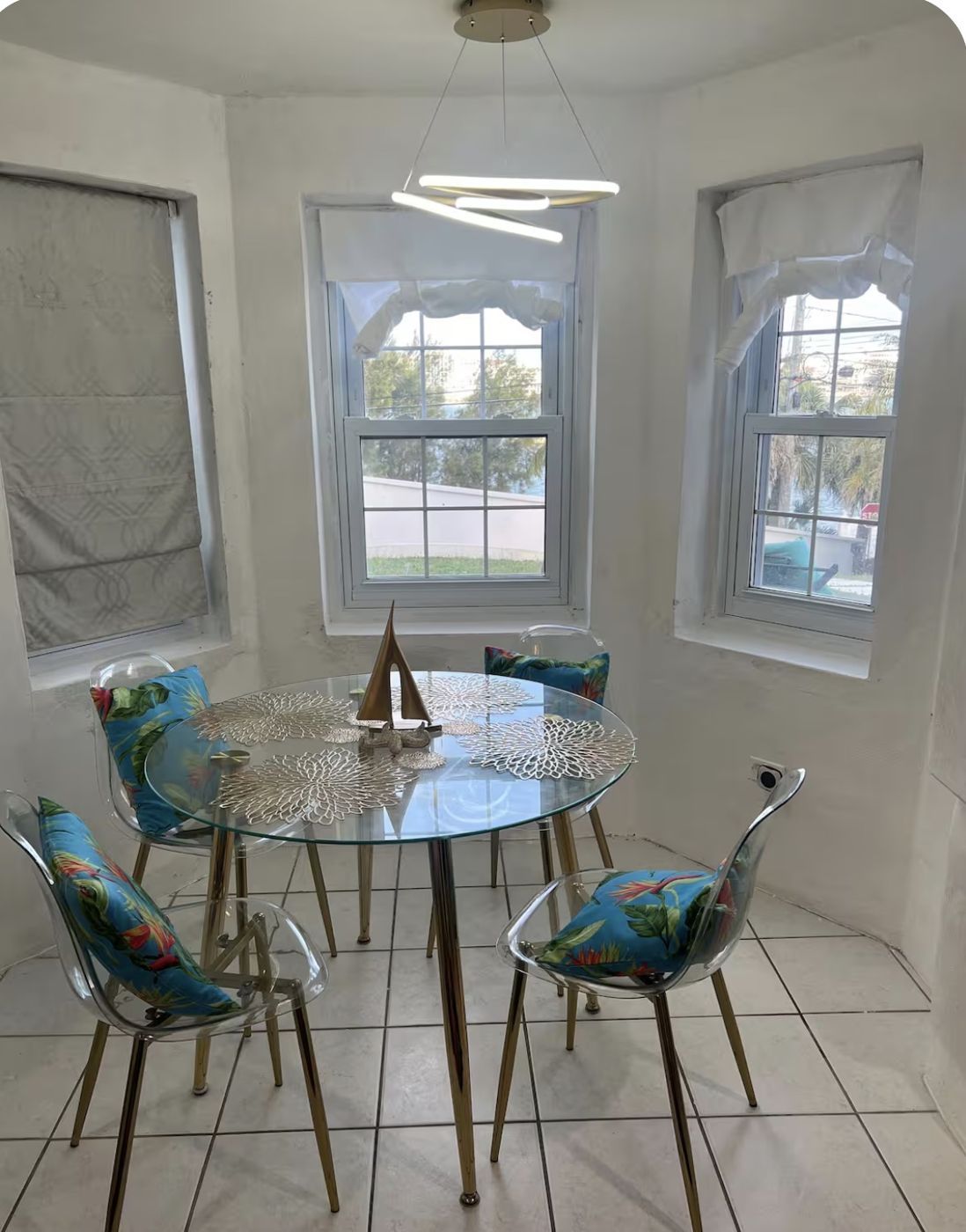 Dining nook with pendant light and bay windows