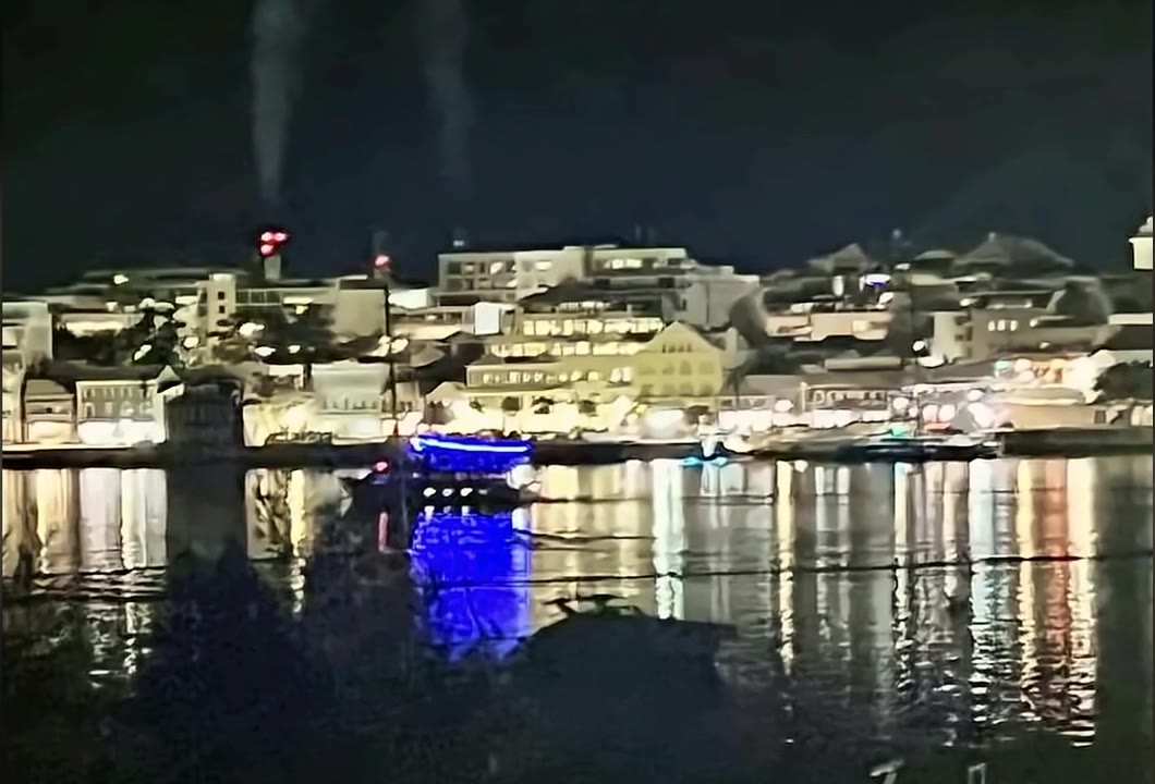 Hamilton's lights reflected across the harbour at night