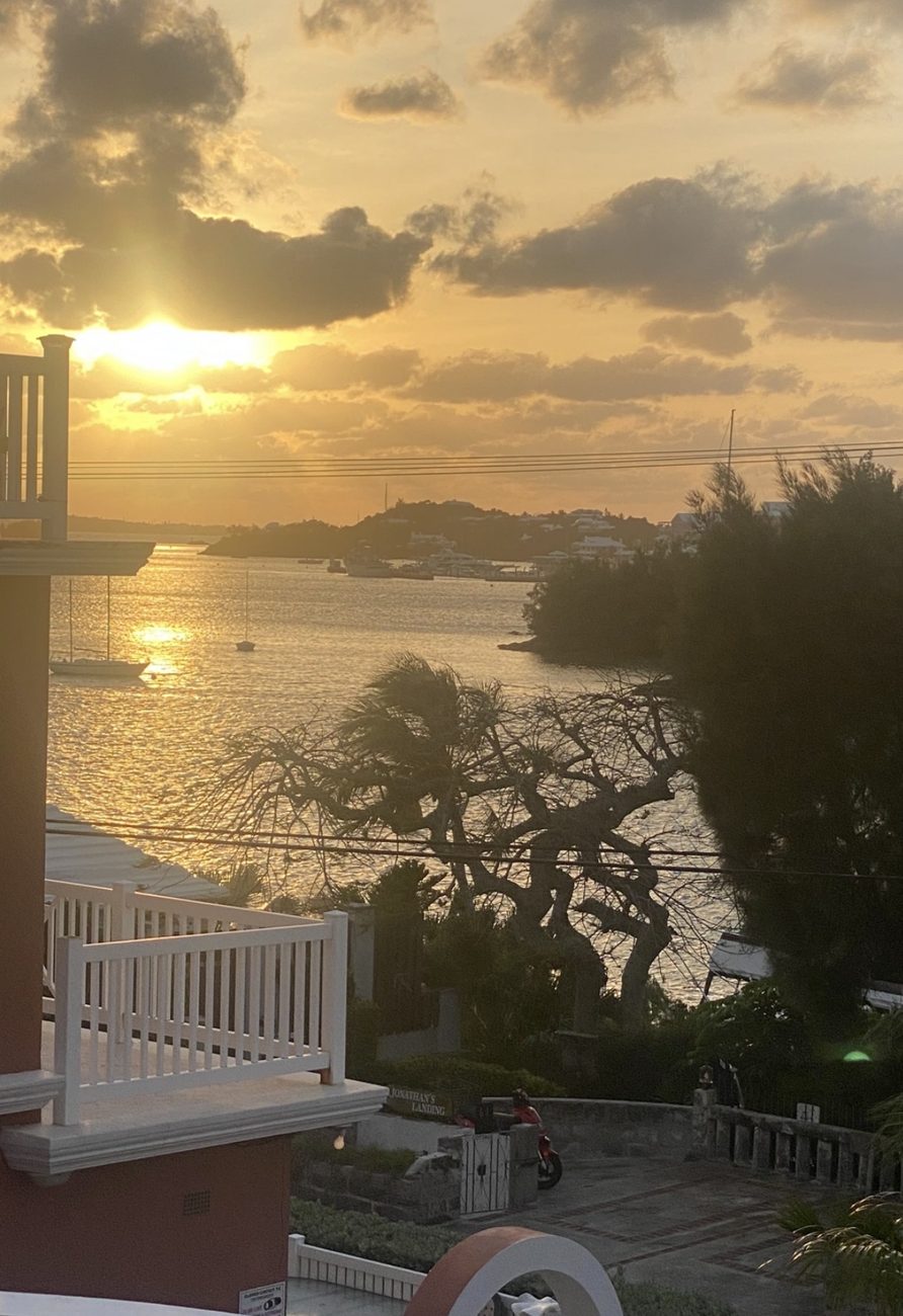 Golden sunset over Hamilton Harbour with sailboats at anchor, seen from Aqua Viva
